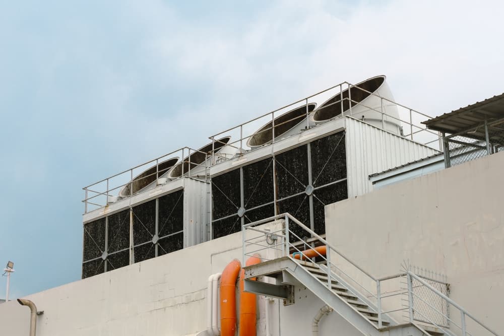 Why is summer heat hard on facility cooling systems